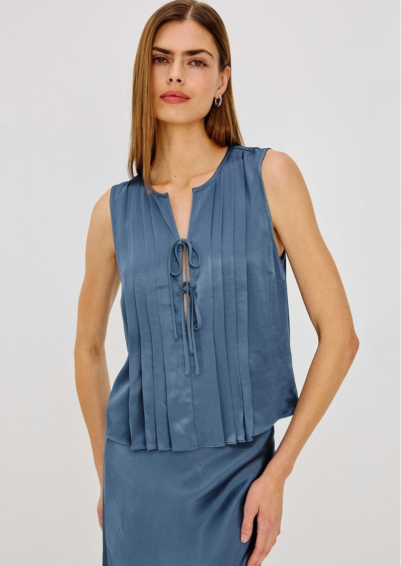 Model wearing Rails AJA sleeveless satin blouse in Atlantic blue with pleated front and tie detail