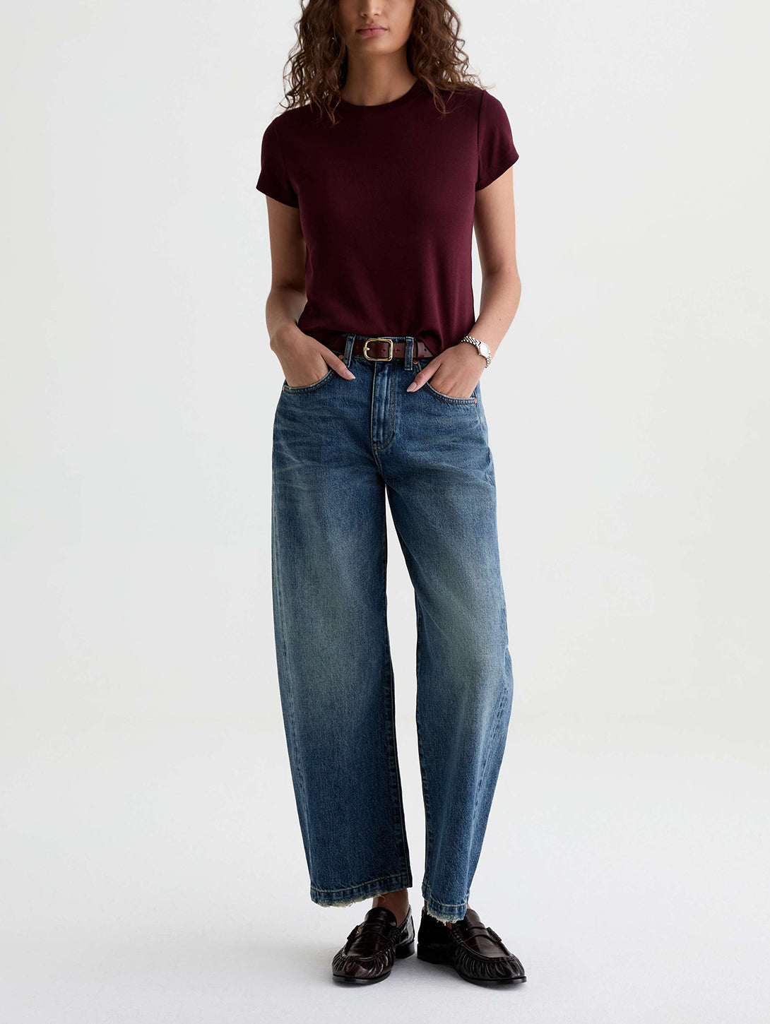 Model wearing AG Hattie wide-leg jeans in medium vintage blue wash with burgundy tee
