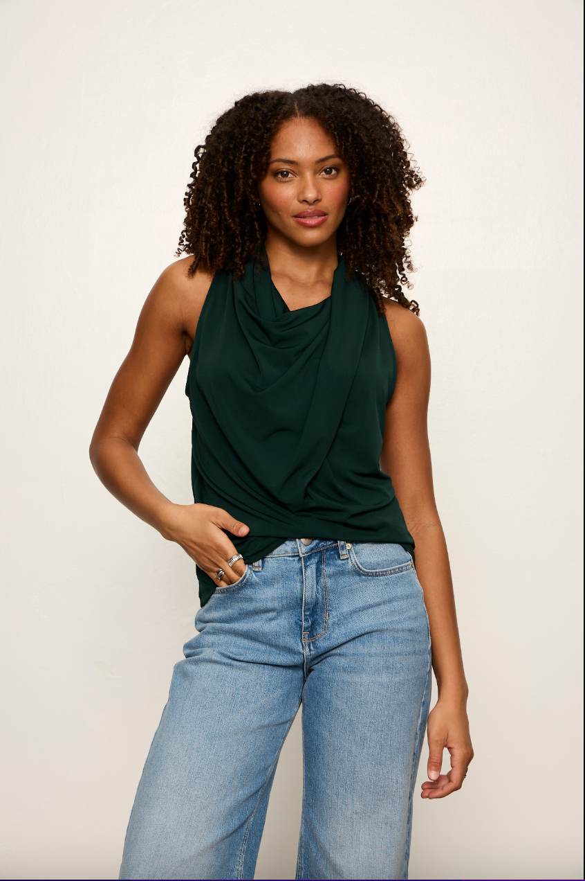 Model wearing Sanctuary Nora Draped Tank in forest green with cowl neckline and blue jeans