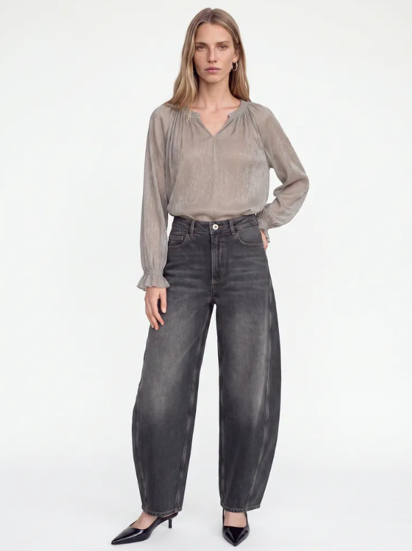 Model wearing Mos Mosh Ximena Glam V-Neck Blouse in Mourning Dove with wide-leg grey jeans