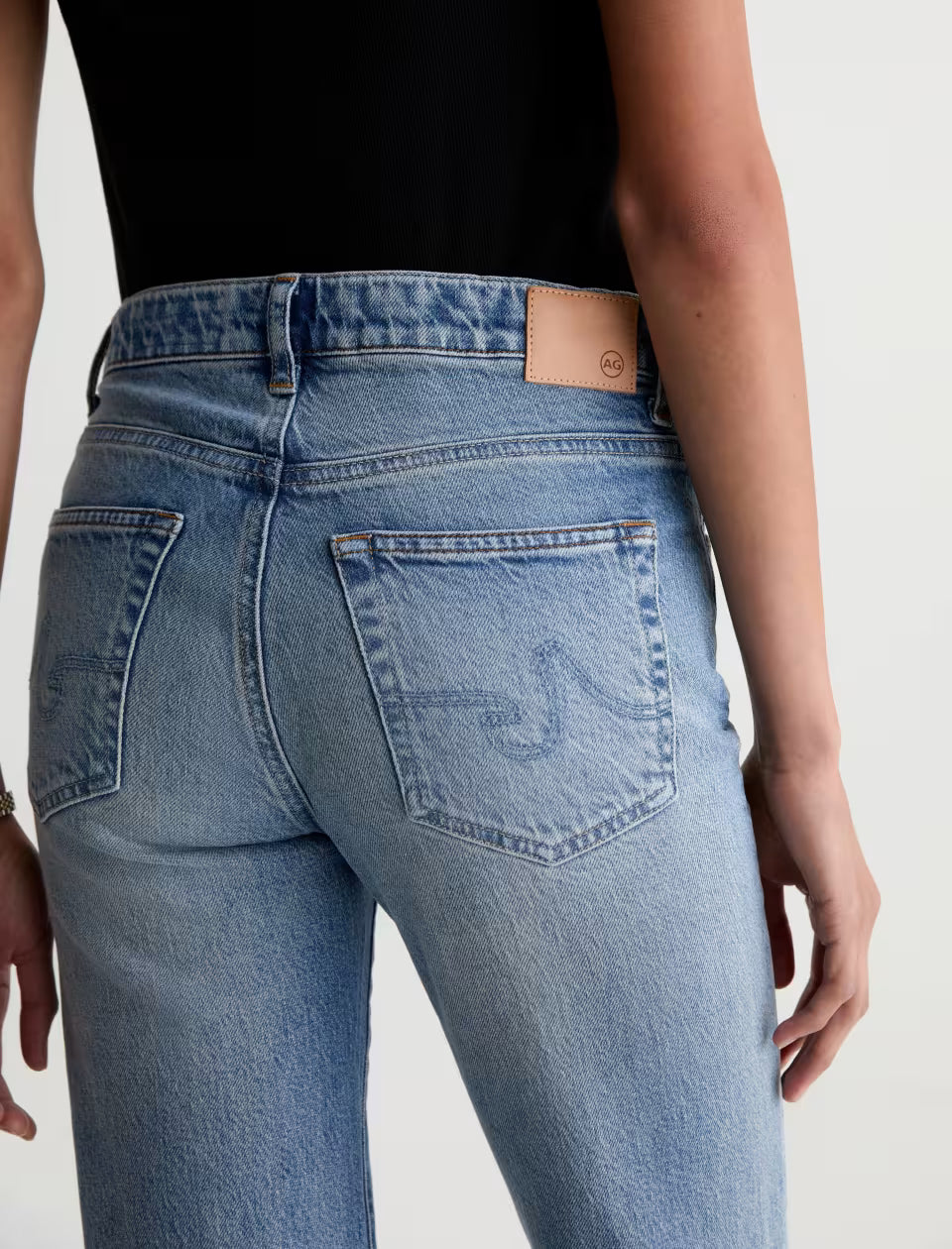 AG Brinley light wash straight jeans back view with leather patch detail