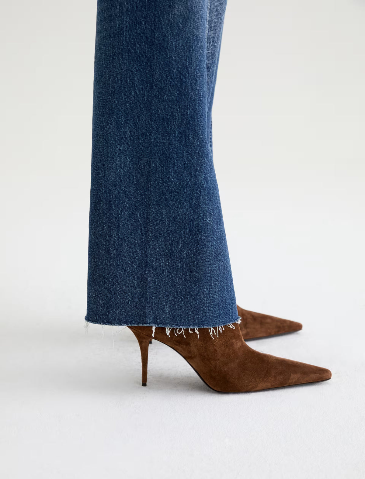 AG Sydney wide-leg jeans in medium blue denim with raw frayed hem