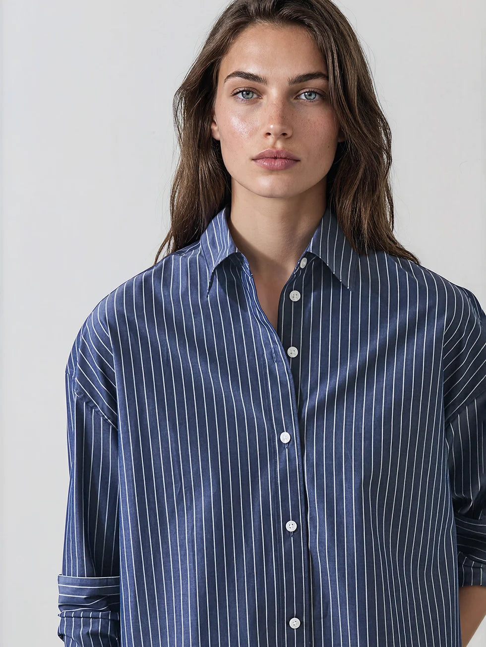 Oversized navy blue pinstripe cotton button-up shirt with long sleeves and collar