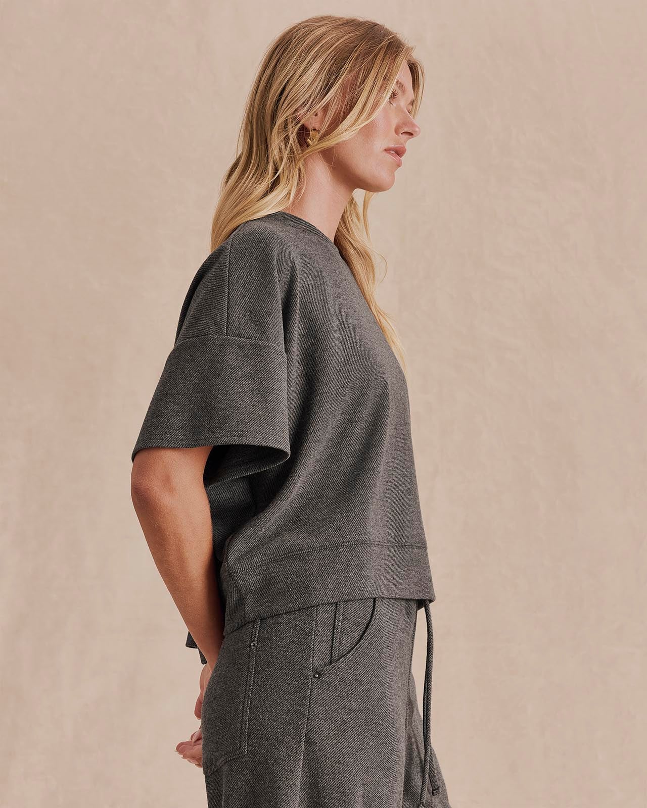 Side view of model wearing Splendid Marlow charcoal cropped short-sleeve knit top