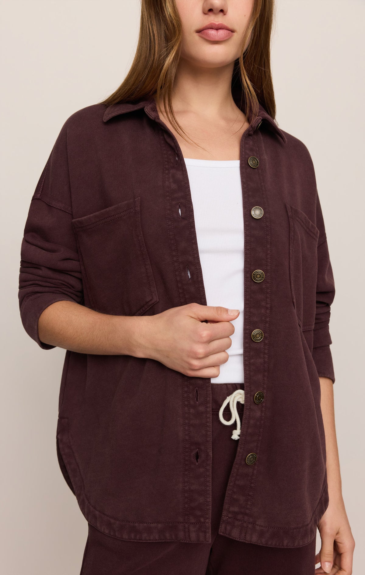 Model wearing Z Supply All Day Knit Jacket in Berry Noir over white tank top