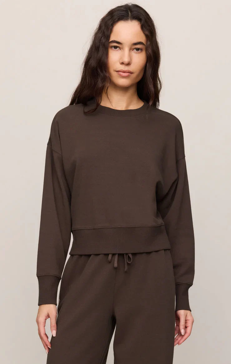 Woman wearing Z Supply Comeback Sweatshirt in Eclipse dark brown with matching jogger pants