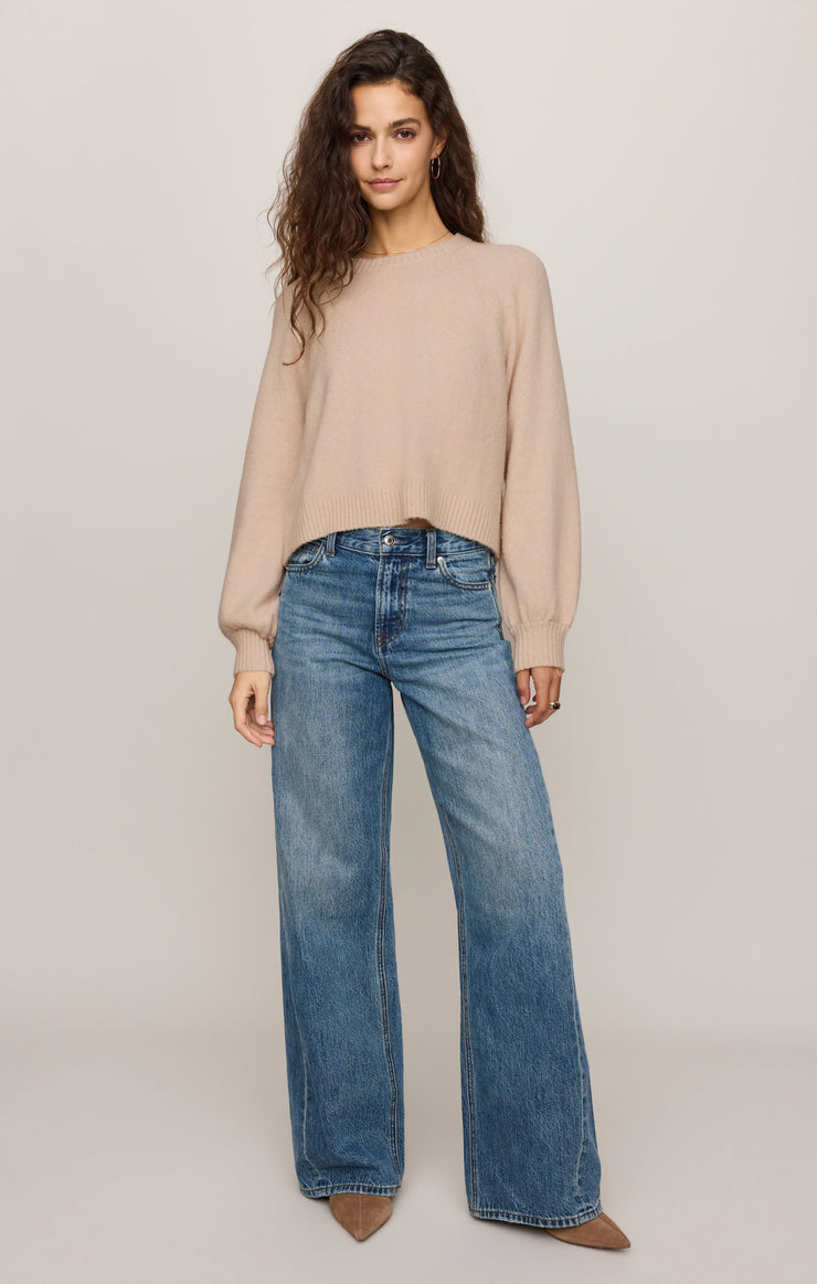 Women's relaxed beige crew neck long sleeve sweater with wide-leg blue jeans