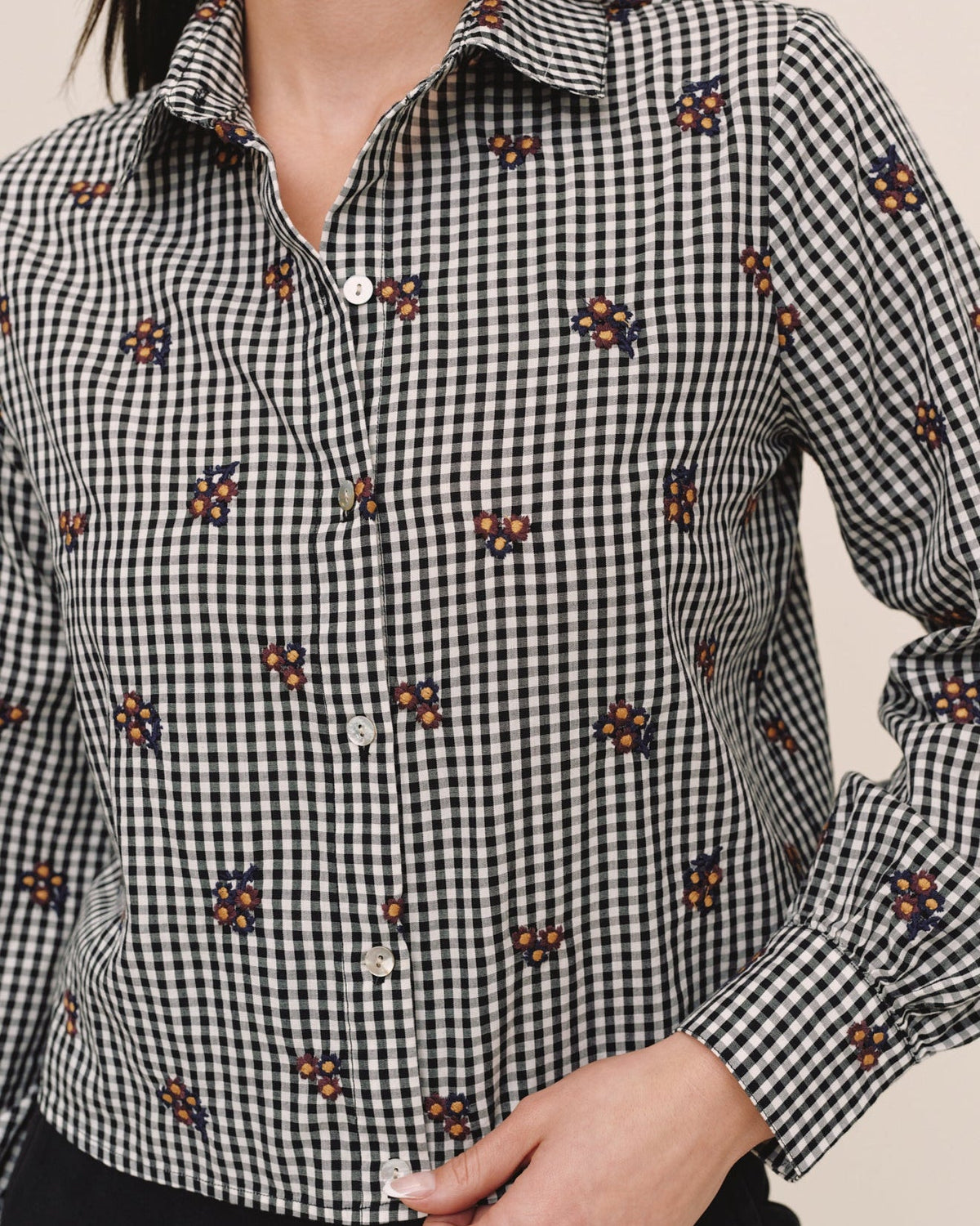 Close-up detail of Bella Dahl black and white gingham button-down shirt with embroidered floral pattern