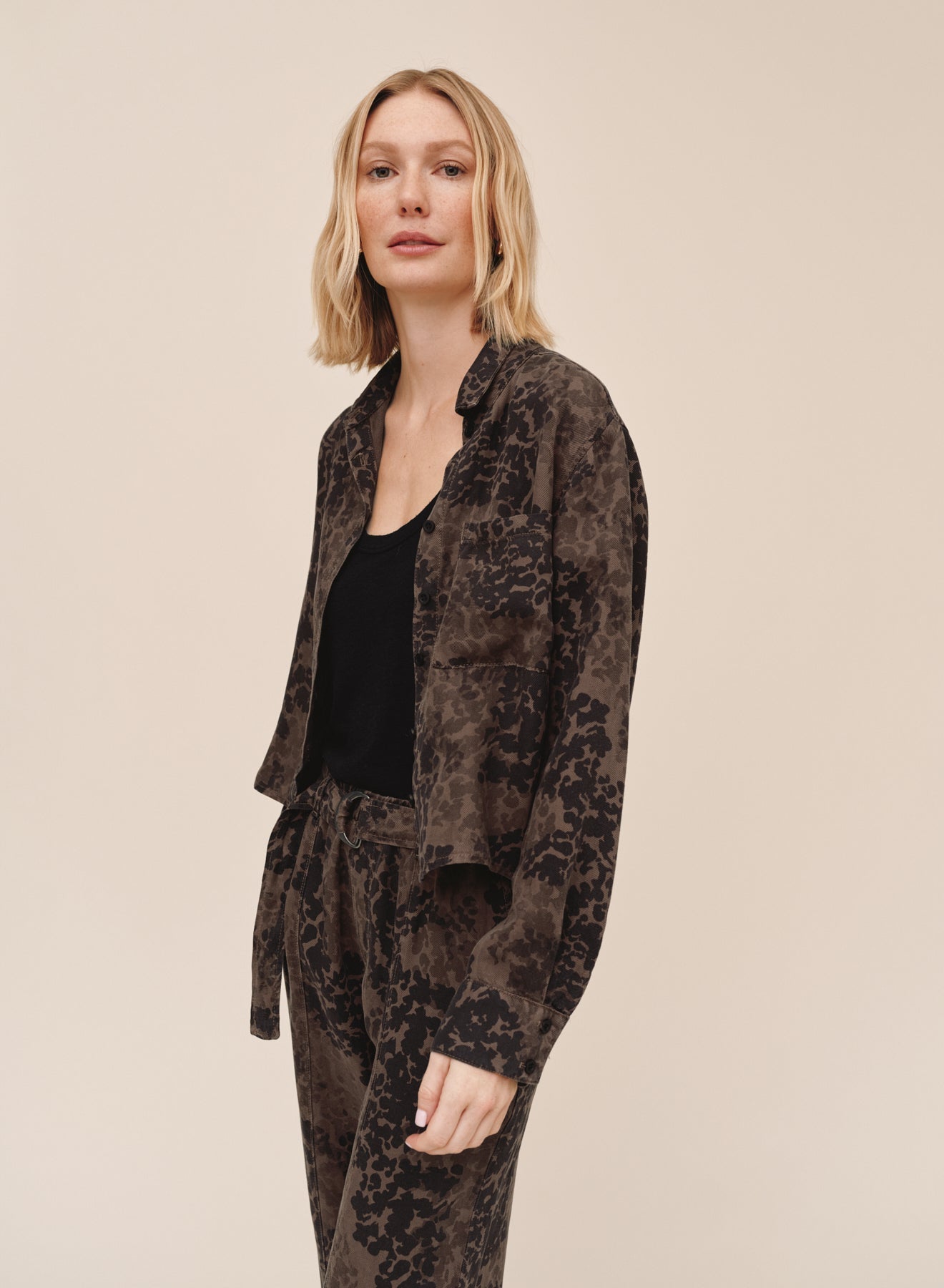 Model wearing Bella Dahl long sleeve crop pocket shirt in ditsy camo print with matching pants