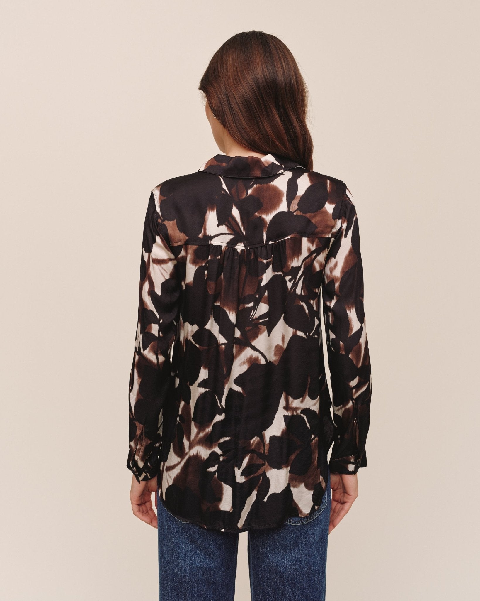 Back view of Bella Dahl long sleeve button down shirt in Shadow Floral Print with blue jeans