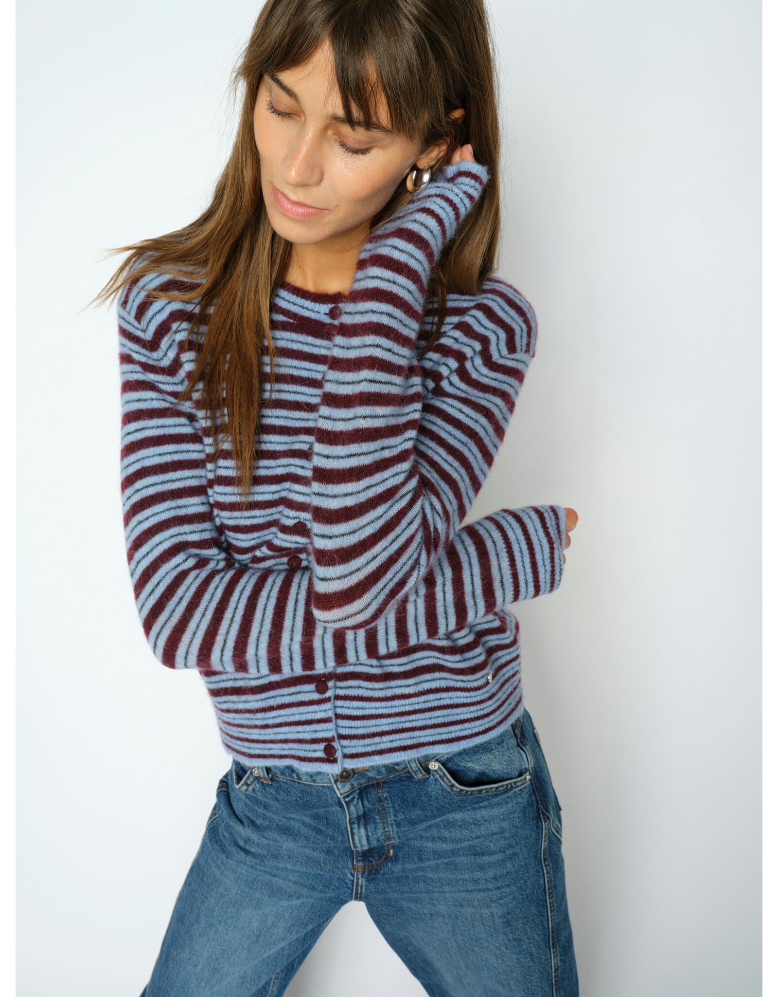 Model wearing Mos Mosh Milvi striped cardigan in burgundy and light blue horizontal stripes with jeans