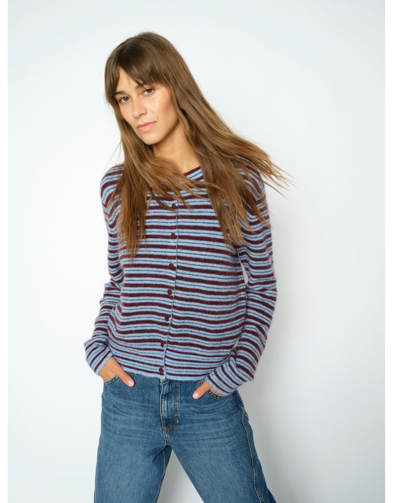 Woman wearing Mos Mosh Milvi striped cardigan in blue and burgundy horizontal stripes with jeans