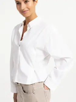 White poplin blouse with button detail and long sleeves on model
