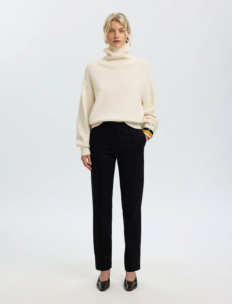 Cream oversized turtleneck knit sweater with ribbed collar and cuffs