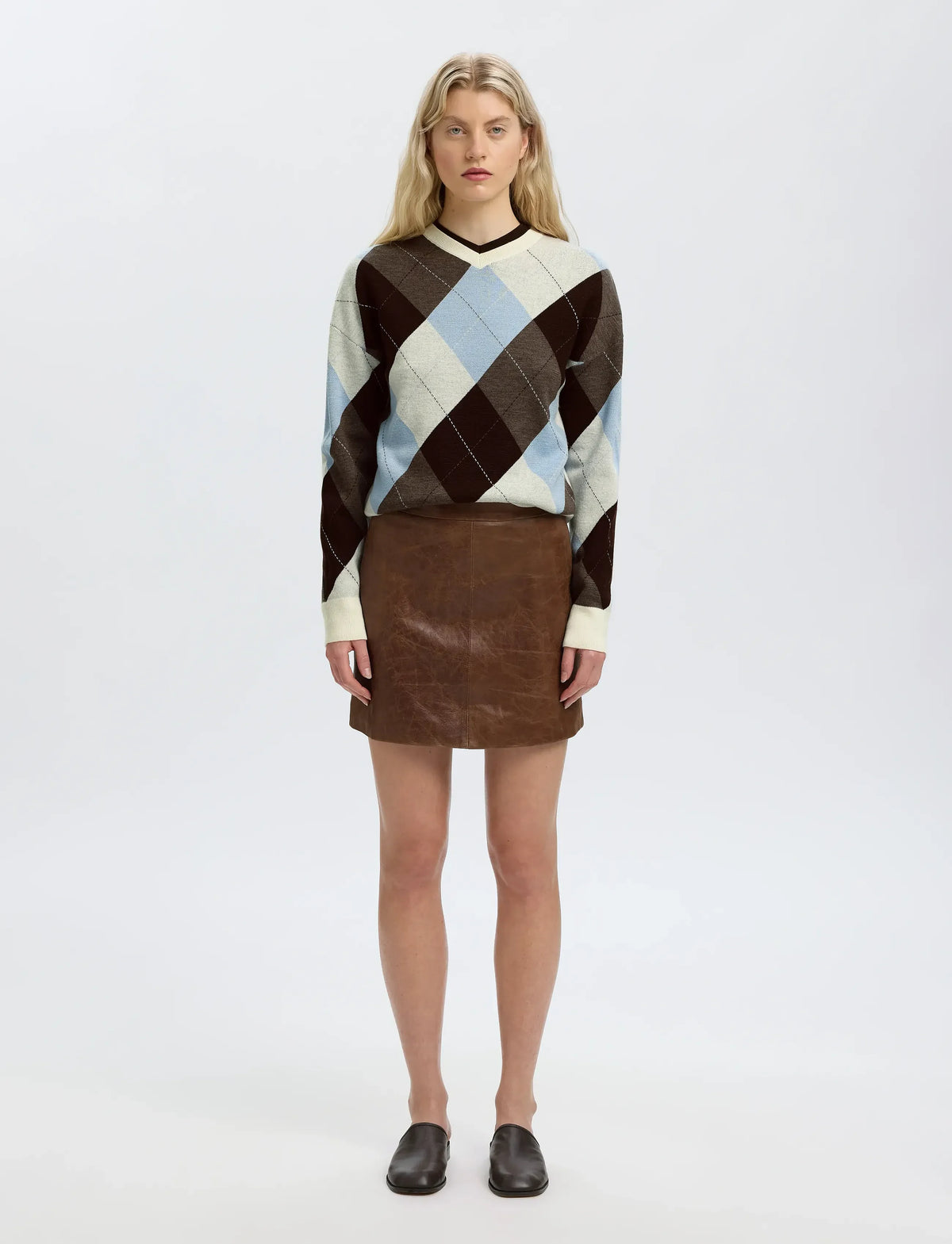Oversized argyle knit sweater in brown, cream, and blue with V-neck