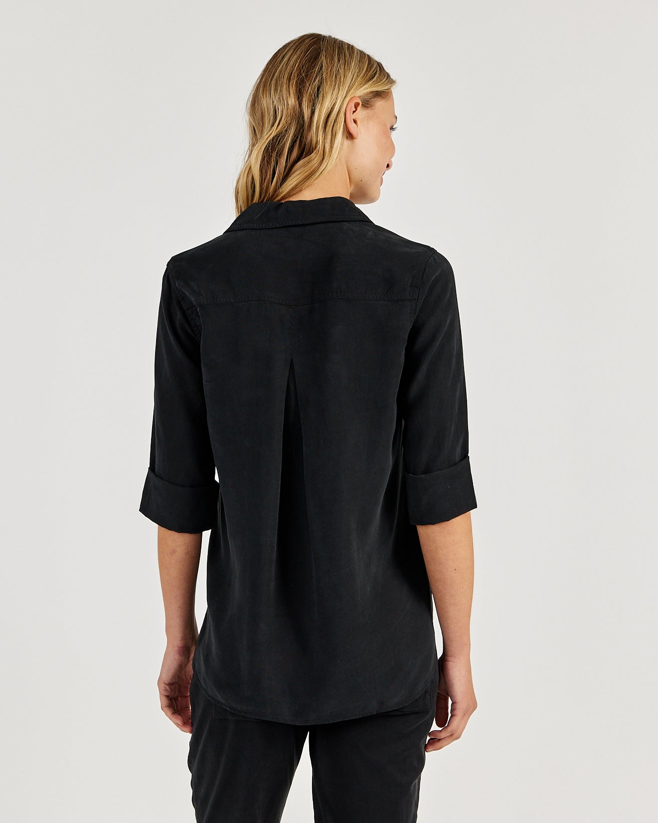 Back view of Bella Dahl Shirt Tail Button Down in Vintage Black with rolled sleeves