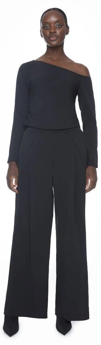 Black wide-leg full-length trousers with high waist and front pleats, styled with matching top