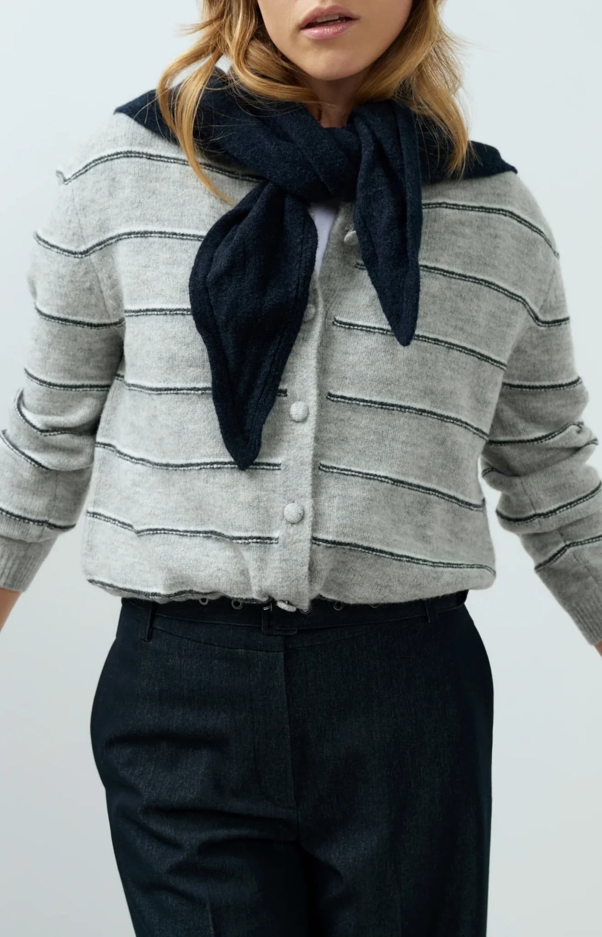 Grey knitted striped cardigan with white pearl buttons and long sleeves