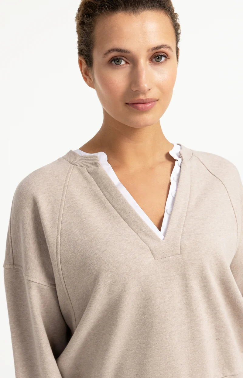Beige V-neck sweatshirt with white woven ruffle collar detail, long sleeves