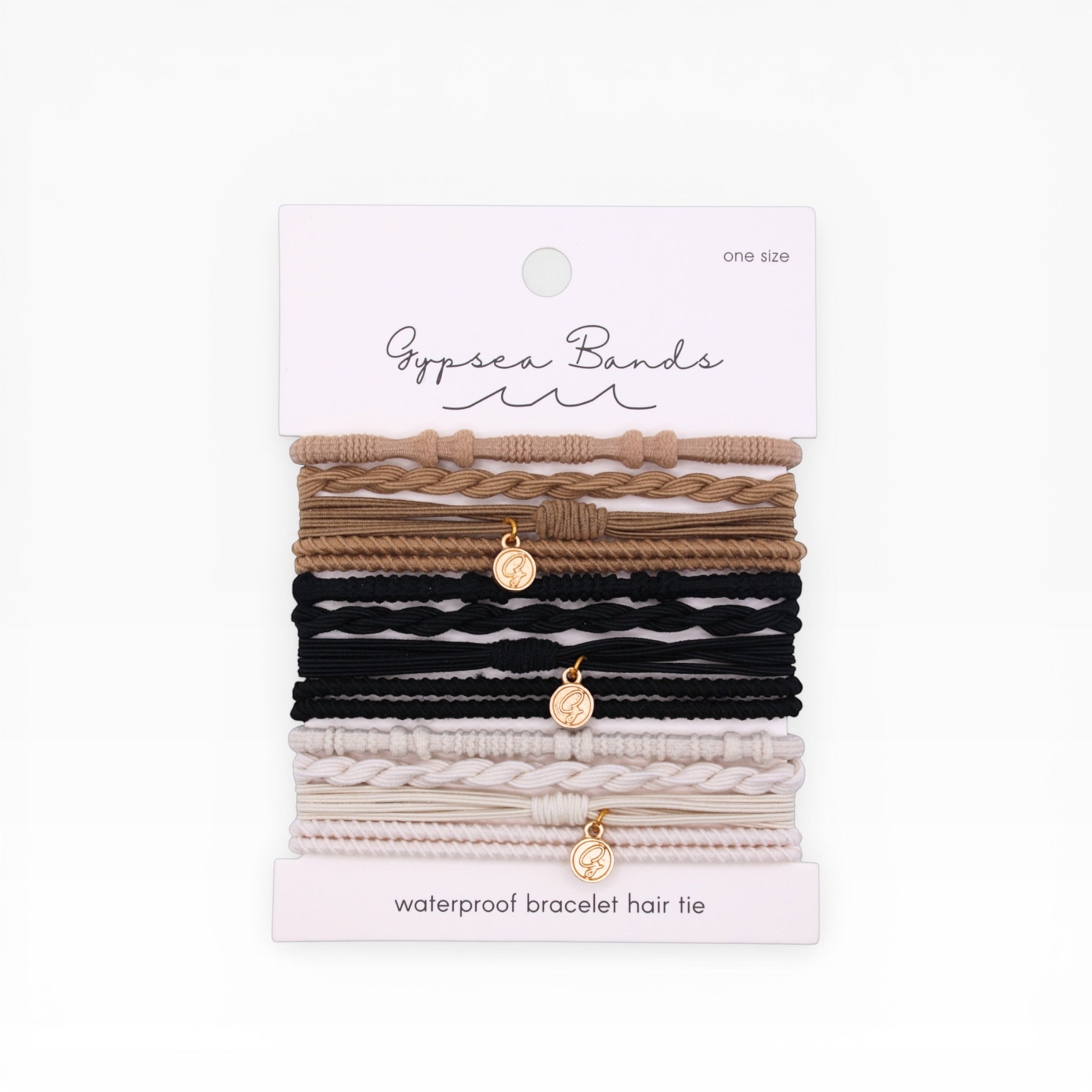 Gypsea Bands Tulum waterproof bracelet hair ties set in tan, black, and cream colorways on packaging card
