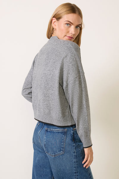 Cropped grey heathered zip-up sweatshirt with black trim, back view