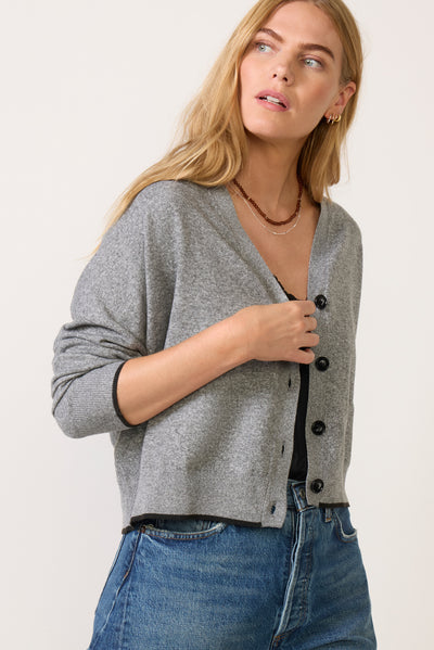 Heather gray button-front V-neck cardigan with contrast trim worn over black top