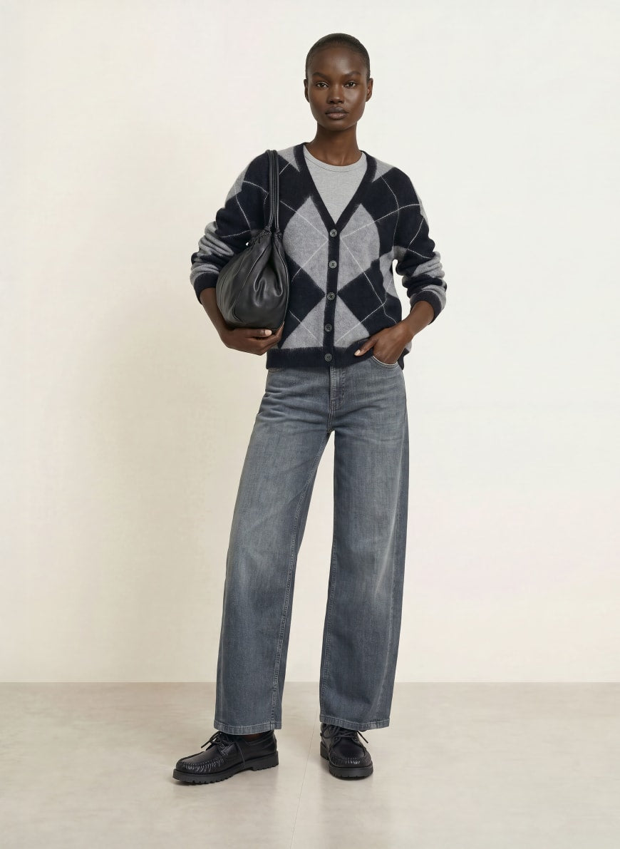 Wide-leg gray washed jeans styled with argyle cardigan and black loafers
