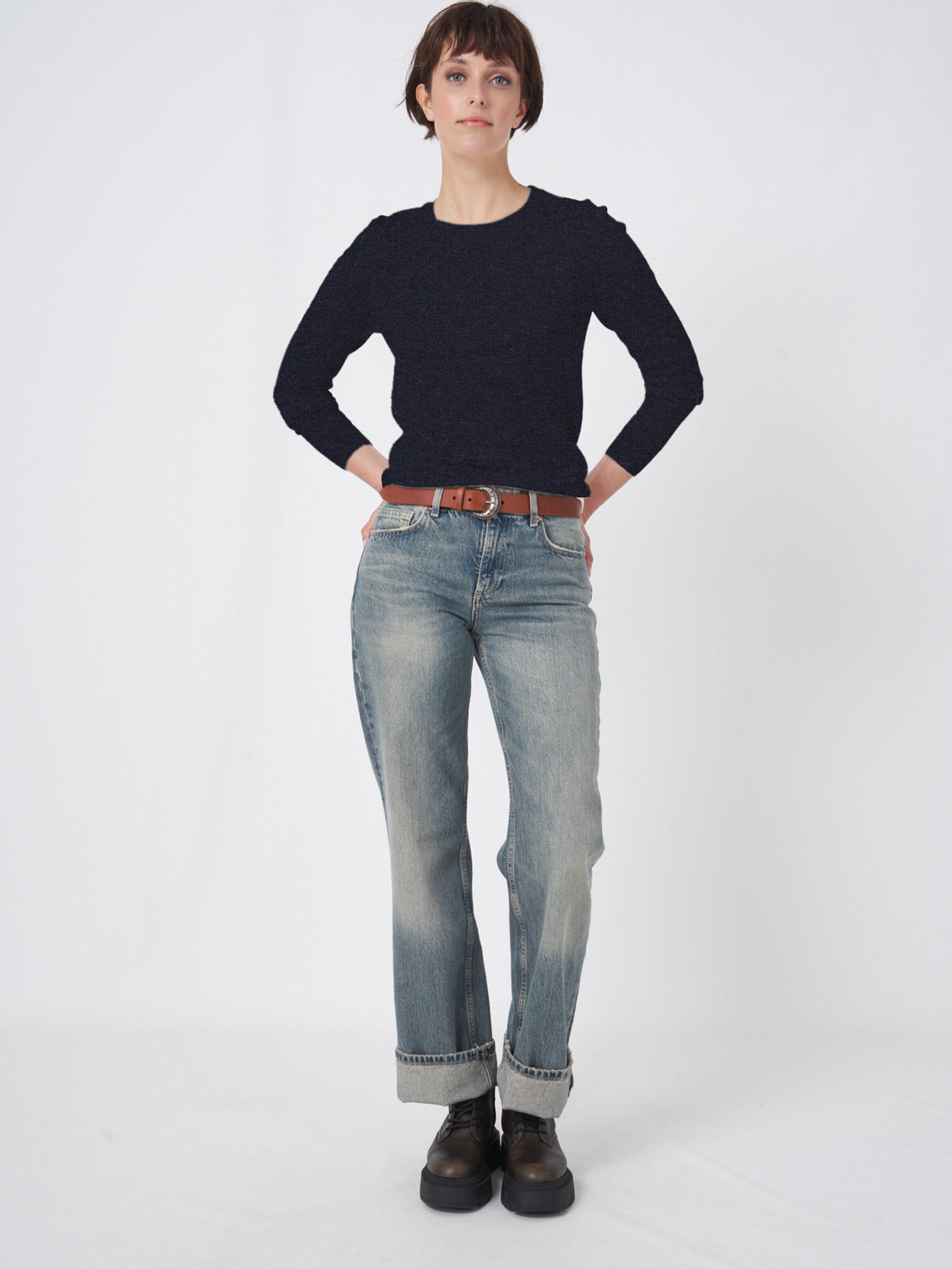 Black organic cashmere knit pullover with subtle puff shoulders and long sleeves