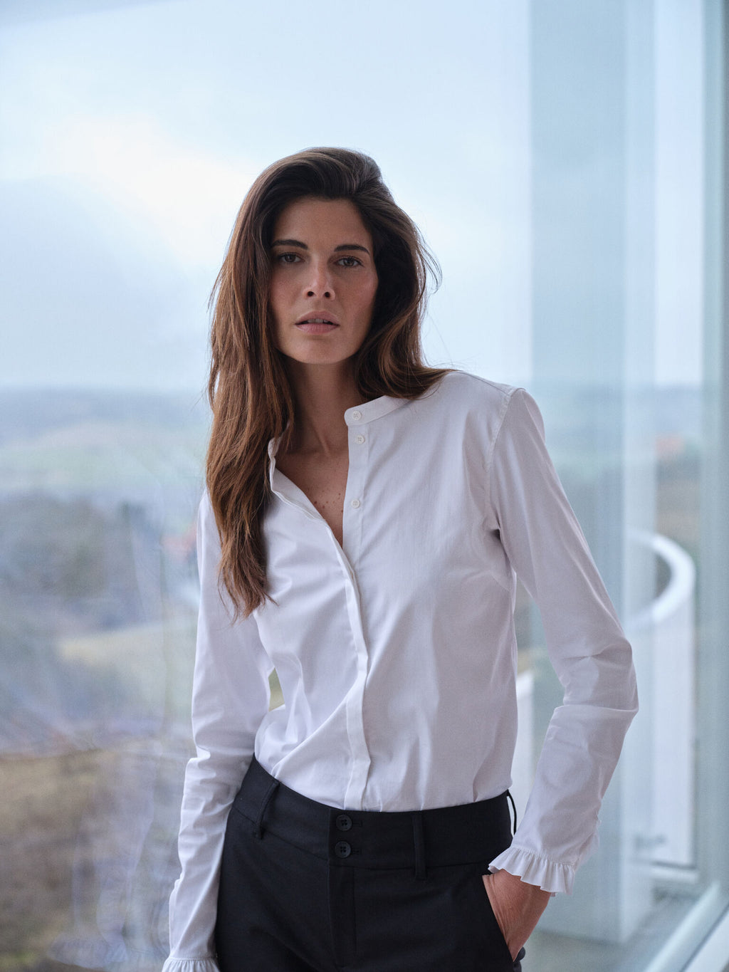 White long-sleeve button-front shirt with ruffle cuffs and collarless neckline