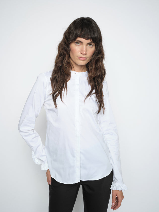 White long-sleeve button-up shirt with ruffle cuffs and collarless neckline
