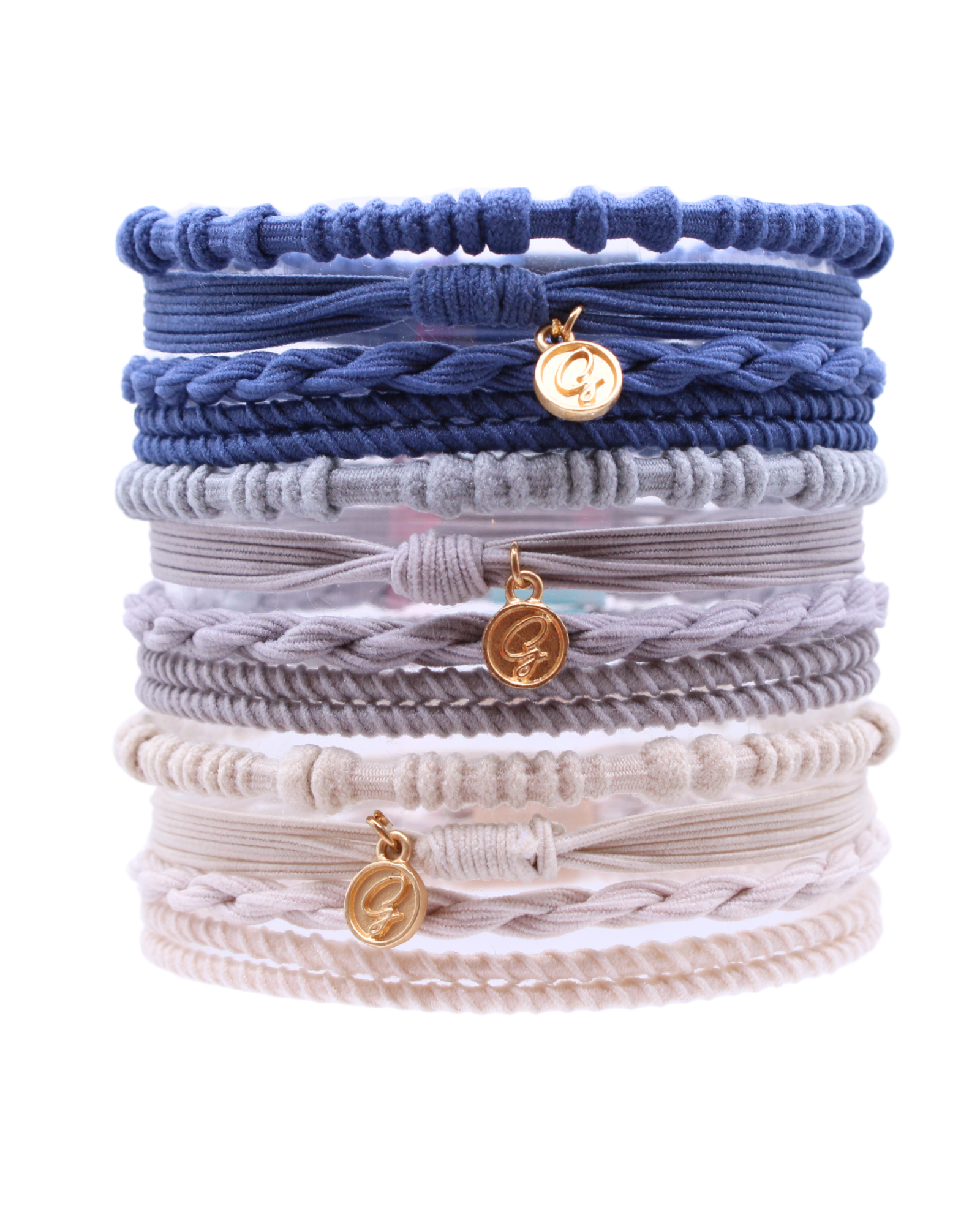 Stacked Gypsea Bands La Jolla hair ties in blue, grey, and cream with gold charms