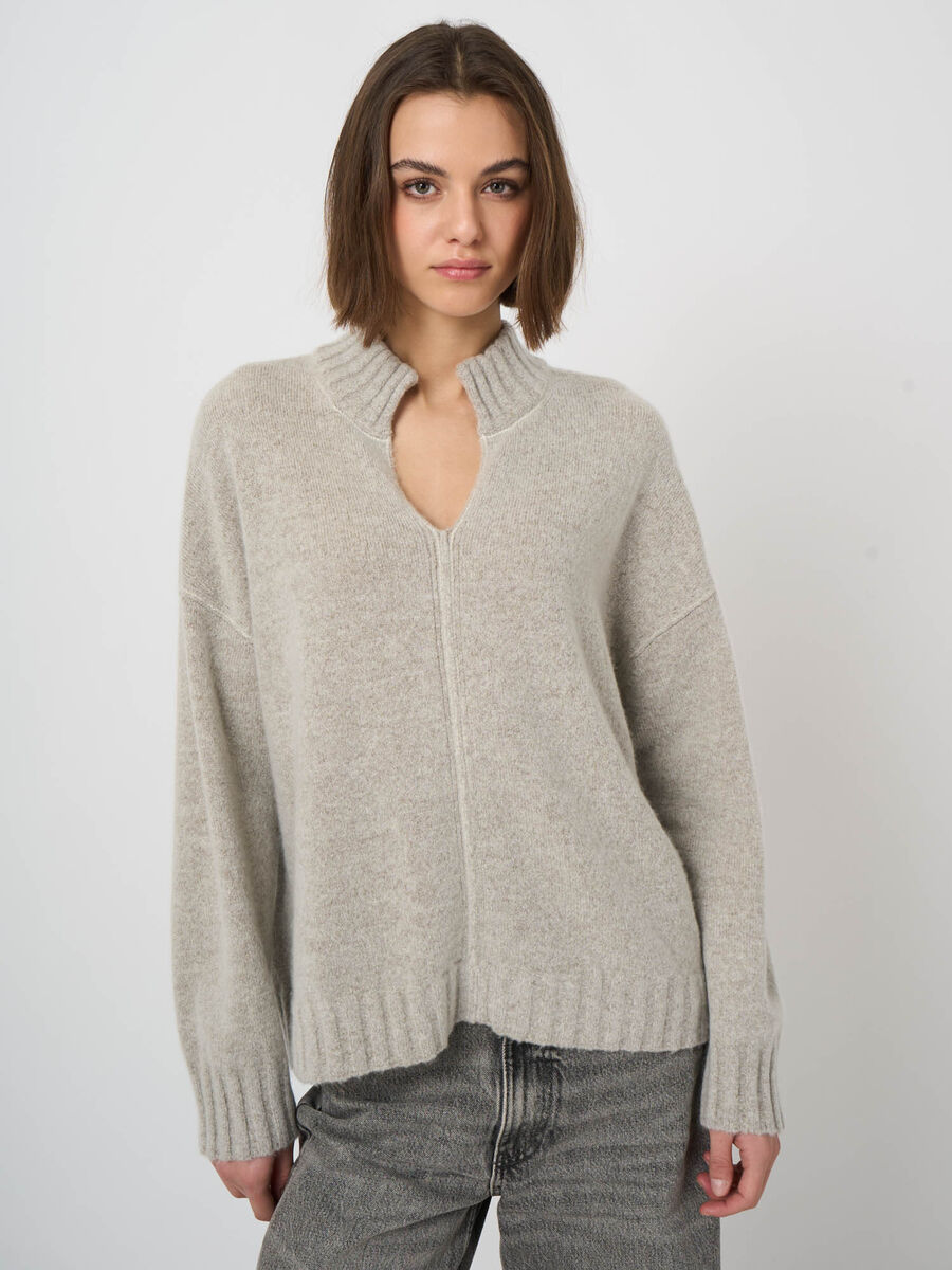 Oversized light beige wool cashmere pullover with mock neck and center seam detail