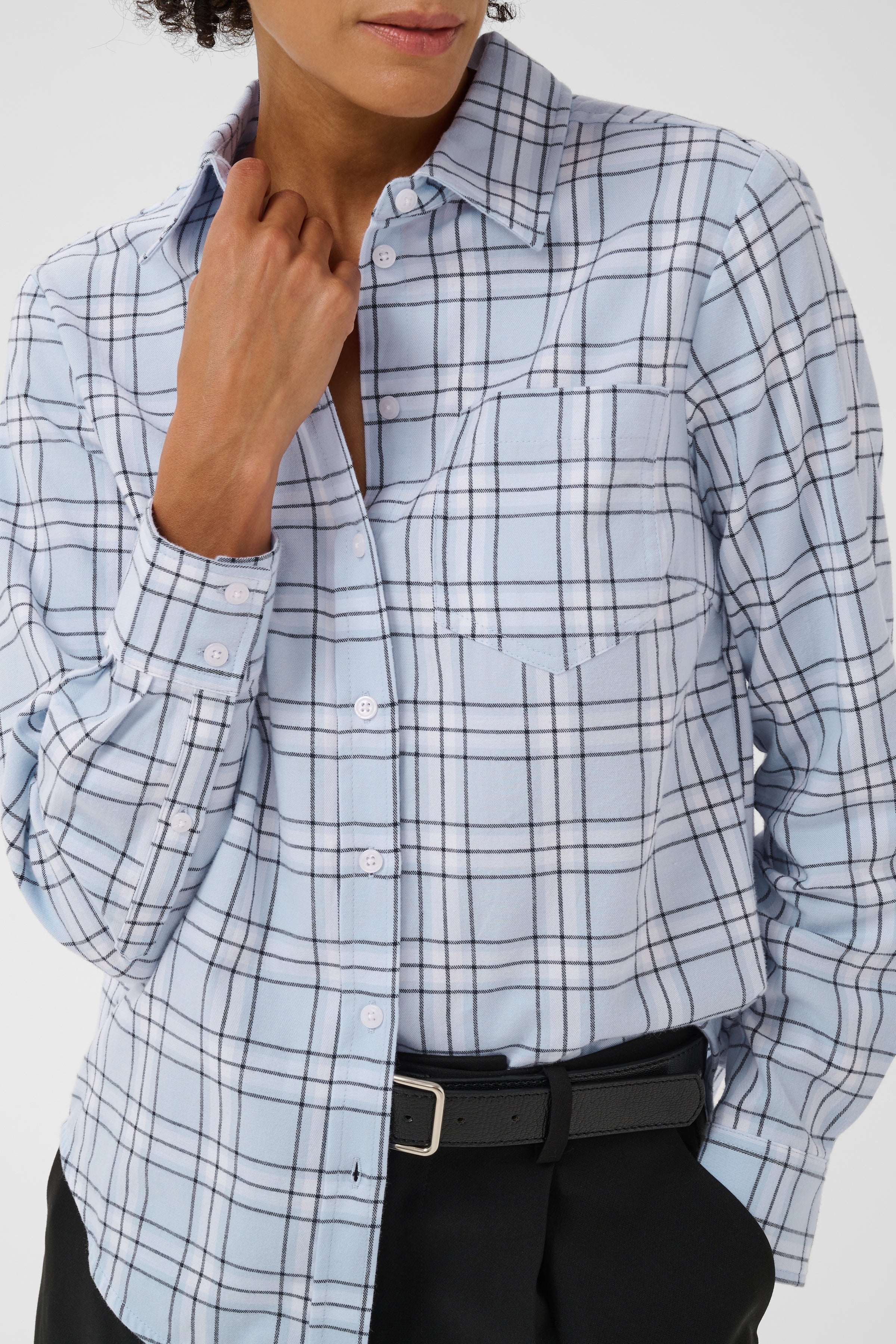 Woman wearing Part Two Yana Shirt in light blue heather check plaid with chest pocket