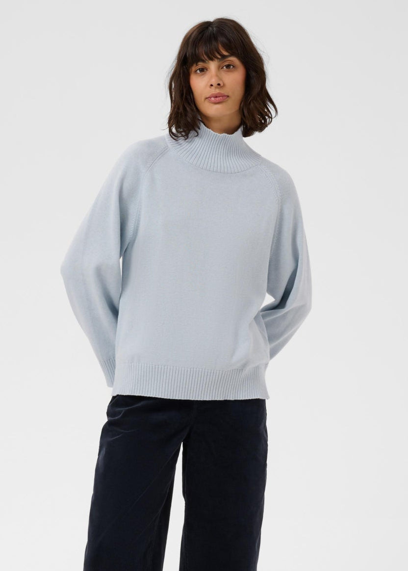 Woman wearing Part Two Chicky Pullover in Gray Dawn, a light blue mock turtleneck knit sweater