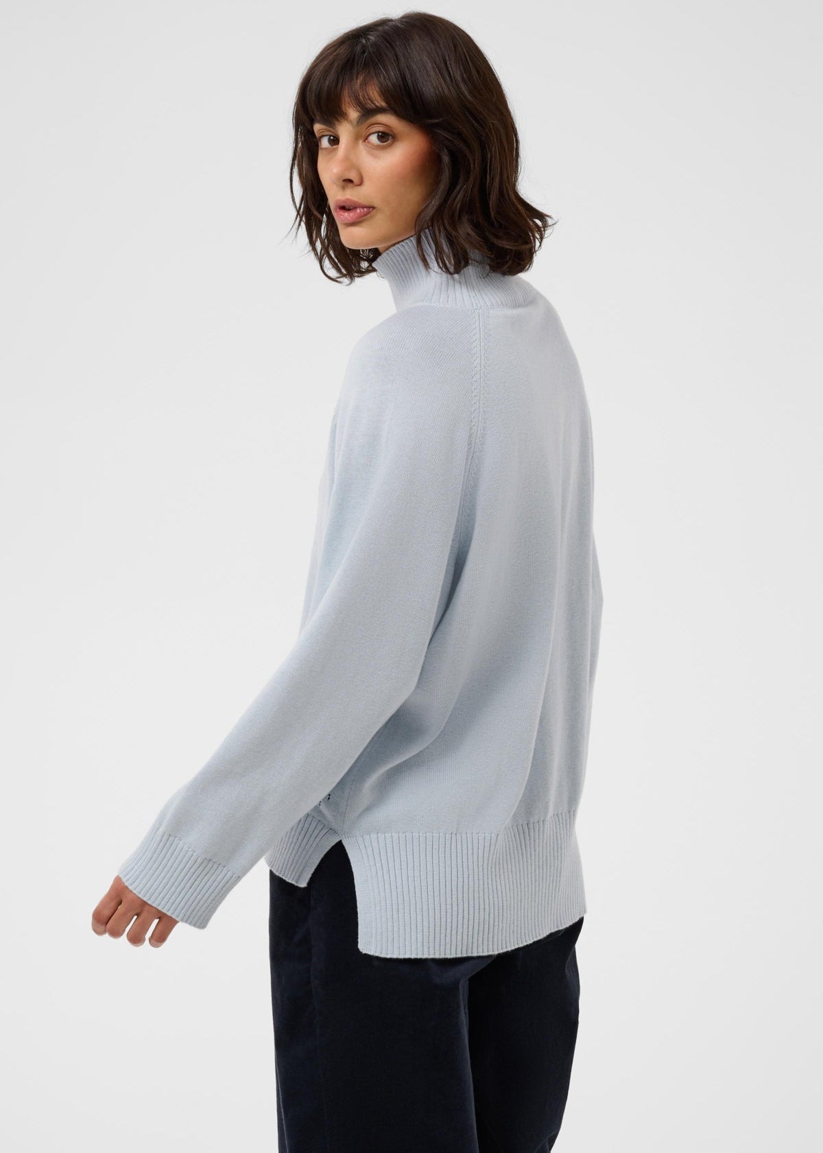 Back view of model wearing Part Two Chicky Pullover turtleneck sweater in Gray Dawn colorway