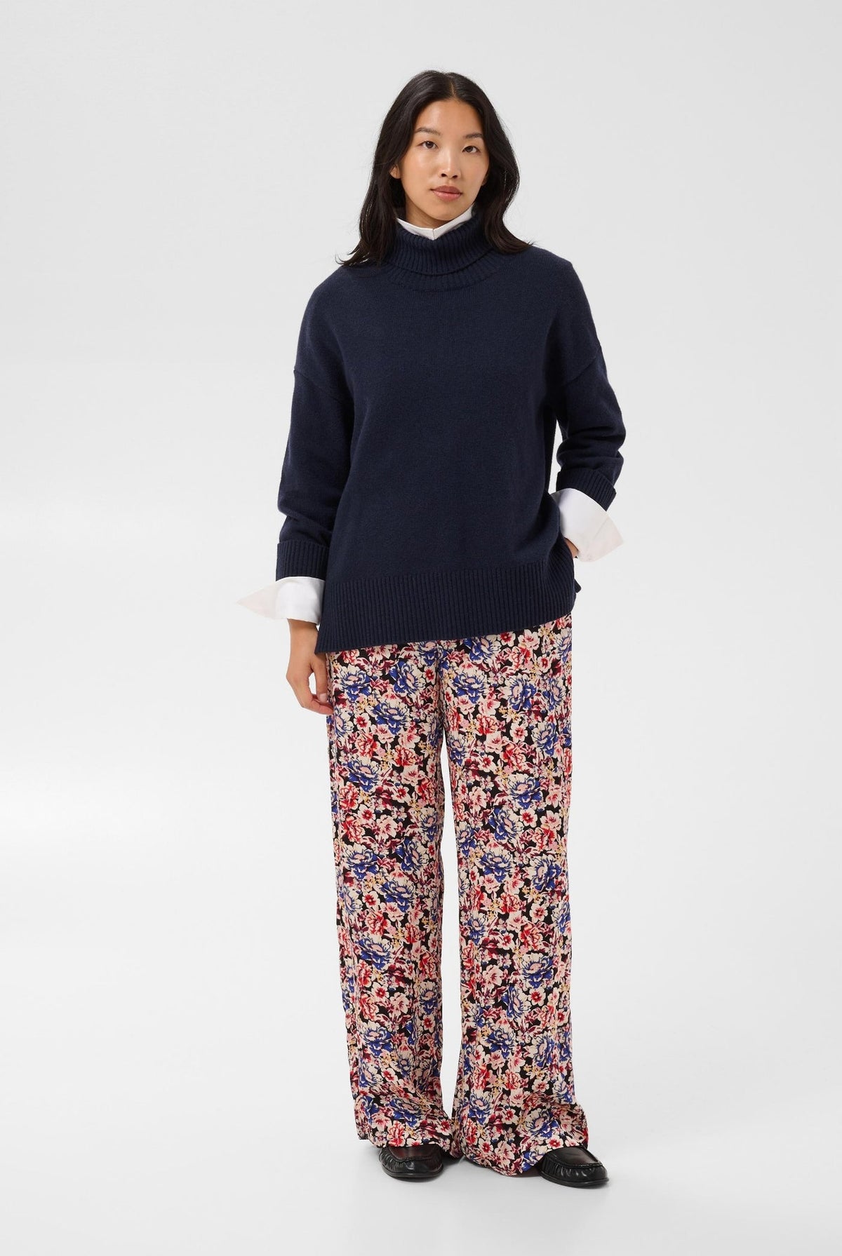 Part Two Corine Pullover navy blue turtleneck knit sweater, worn with floral trousers