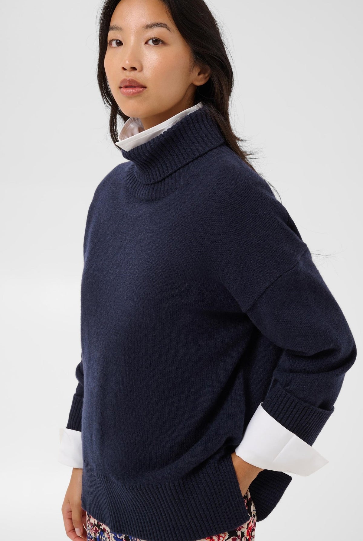 Navy blue turtleneck pullover sweater layered over white collared shirt, relaxed fit