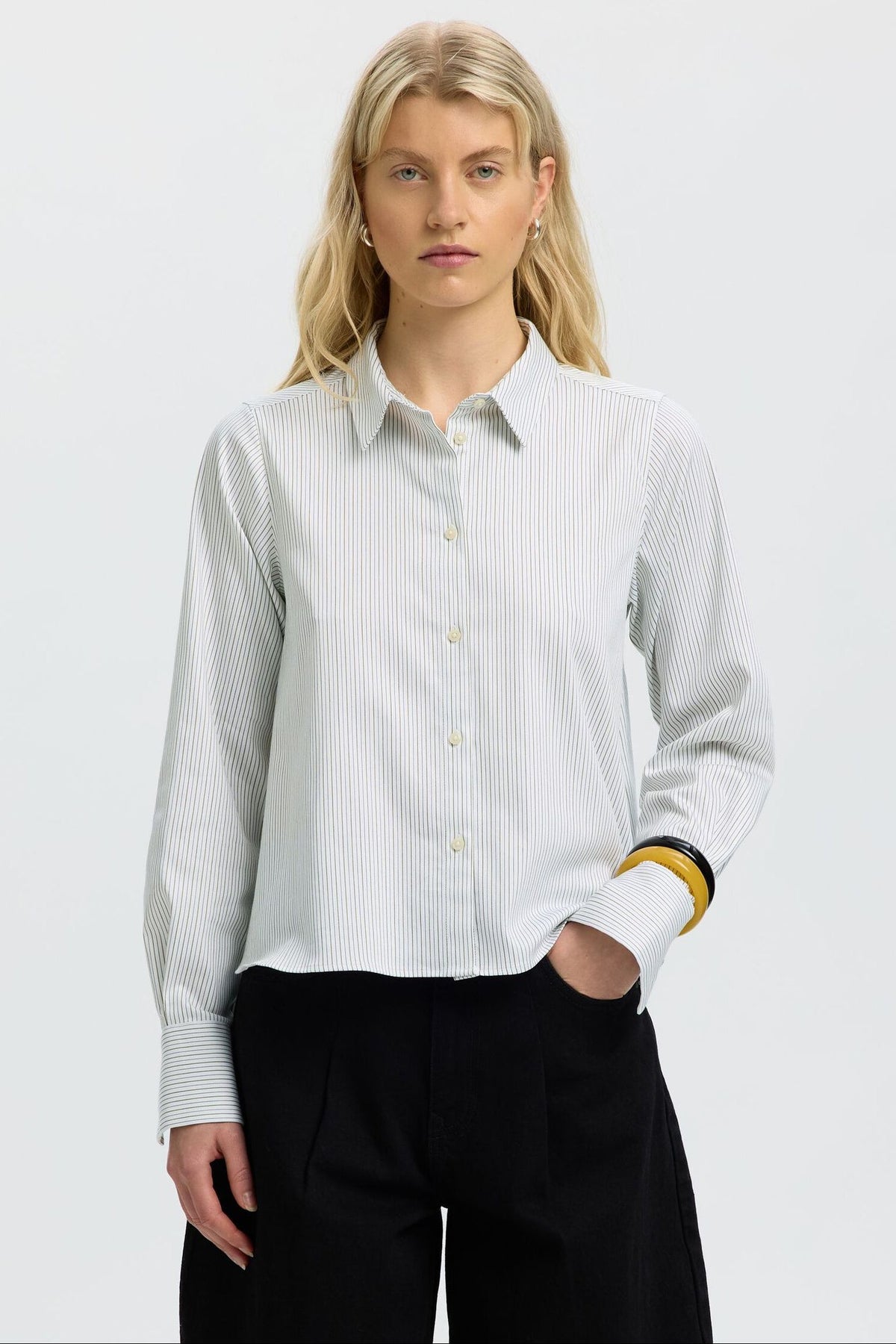 Model wearing SELECTED relaxed fit long sleeve striped button-up shirt in Avocado Oil Stripes colorway