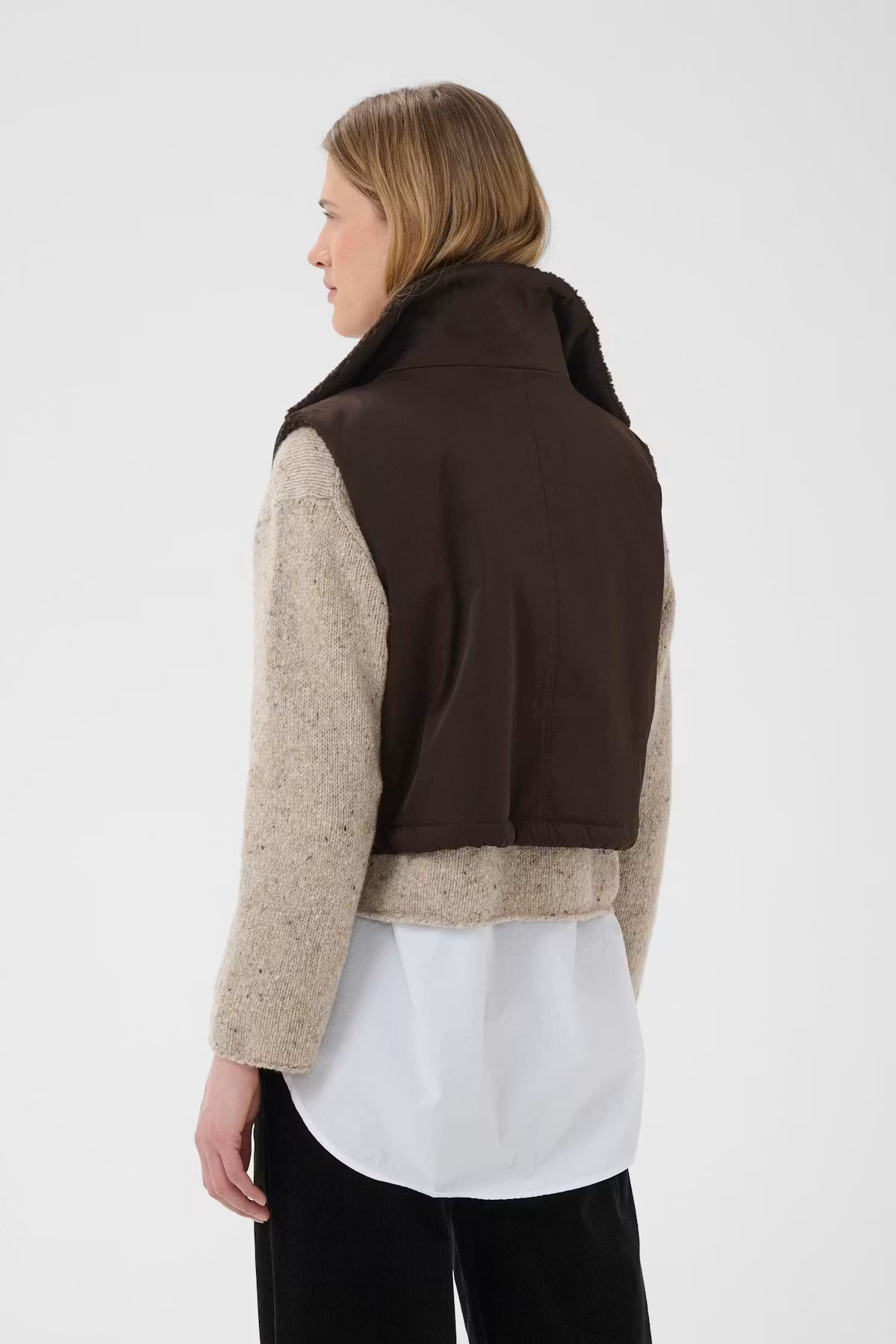 Part Two Cathlin dark brown sherpa vest layered over beige knit sweater, back view
