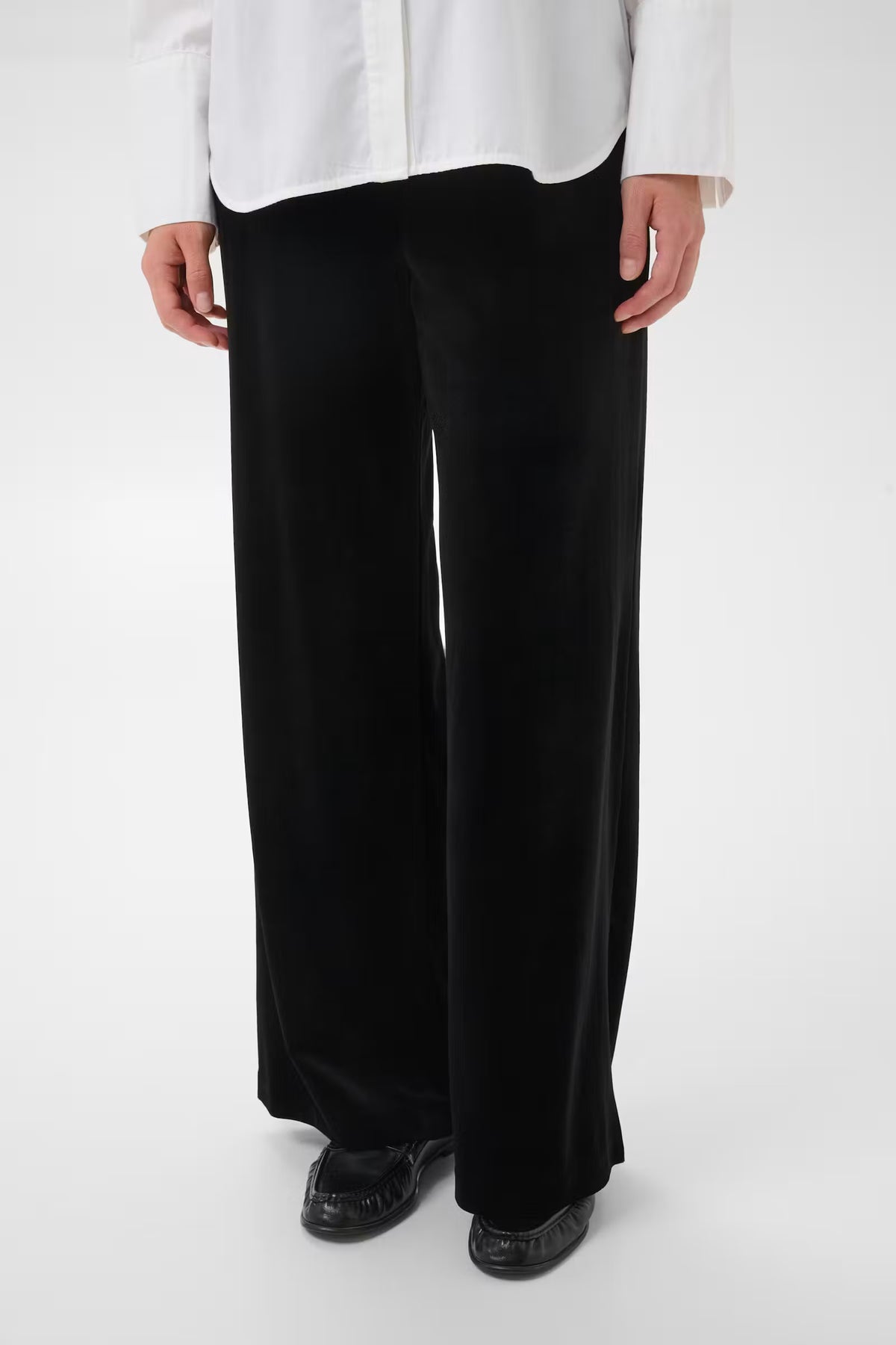Black wide-leg full-length trousers with smooth finish and structured waistband