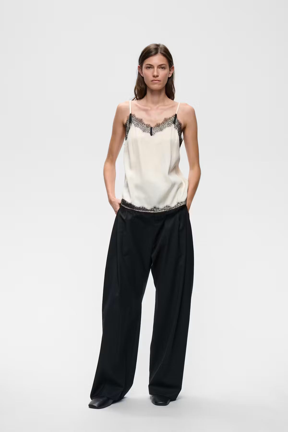 Ivory satin camisole with black lace trim neckline and hem, spaghetti straps