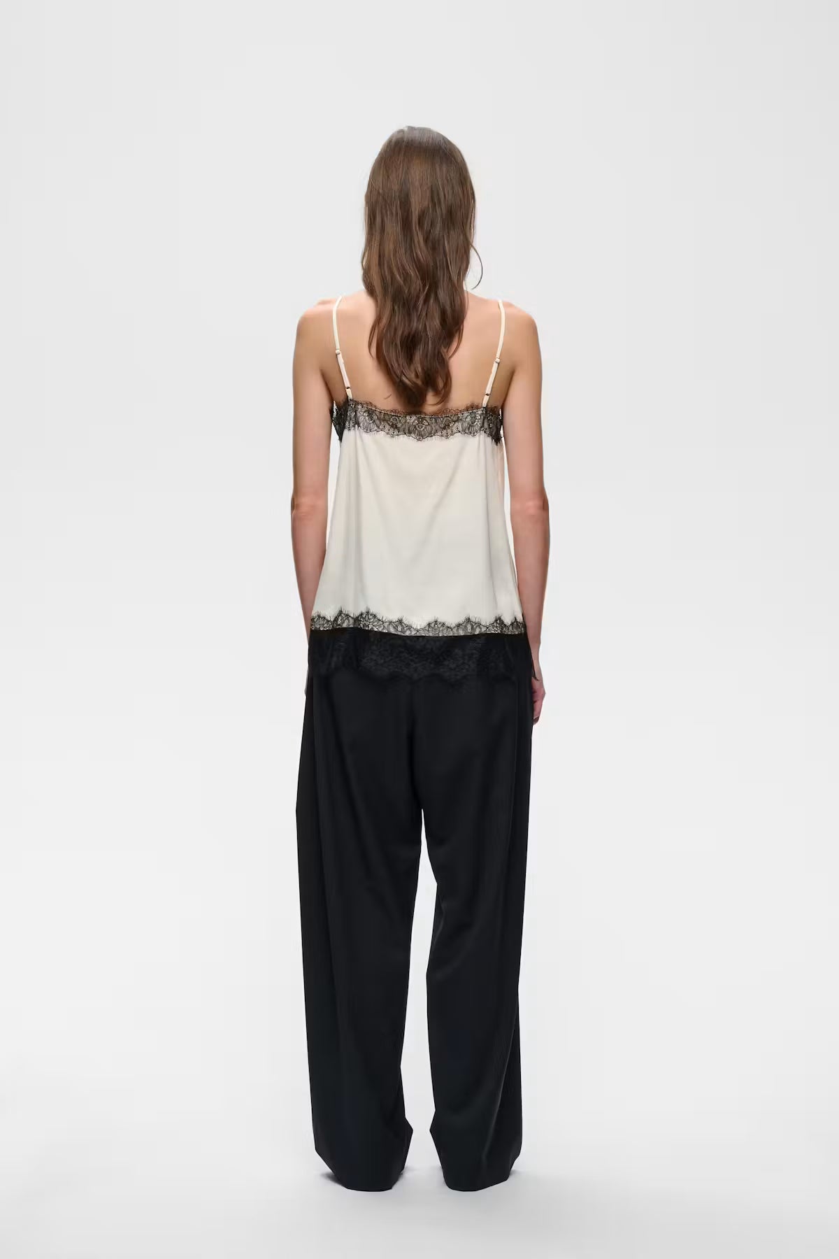 Ivory satin camisole with black lace trim at neckline and hem, back view