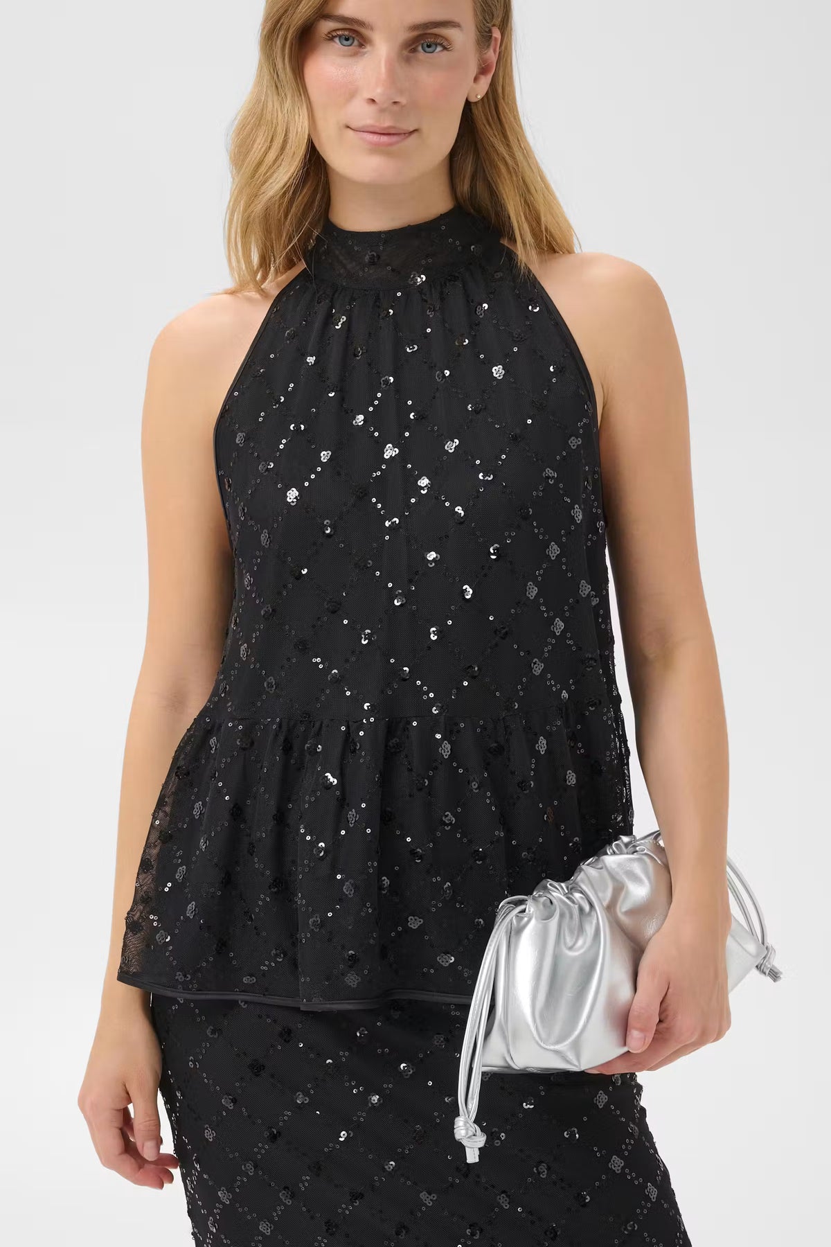 Black sleeveless halter top with silver sequin geometric pattern and ruffle hem tier