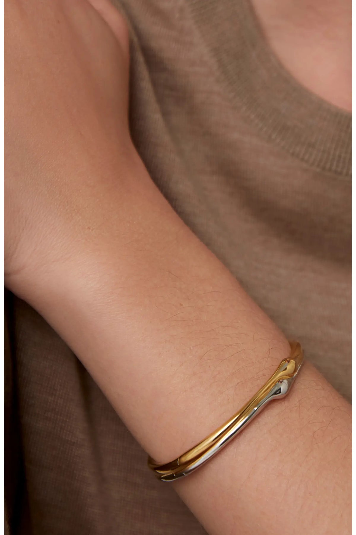 Jenny Bird Egret Bangle in two-tone gold and silver worn on wrist