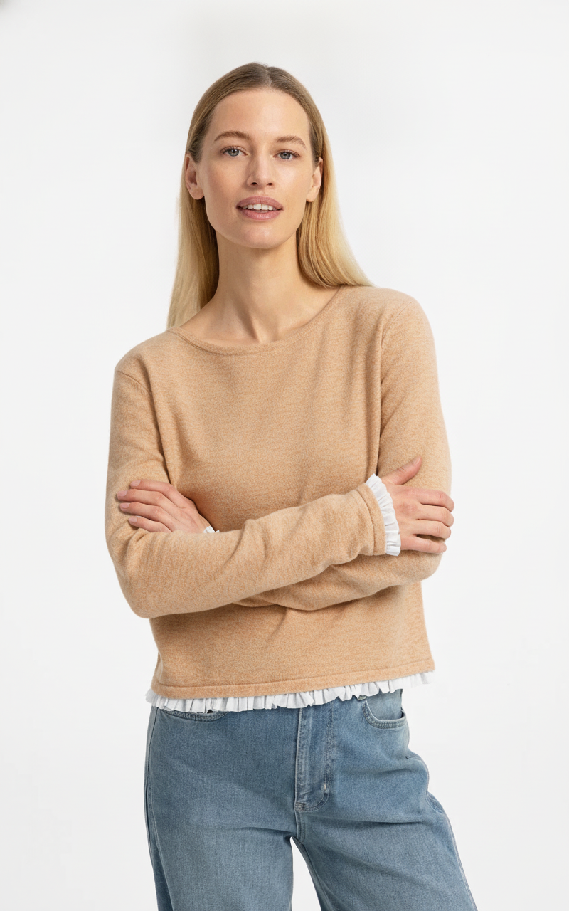 Camel fine knit sweater with white ruffle woven cuffs and hem, paired with jeans