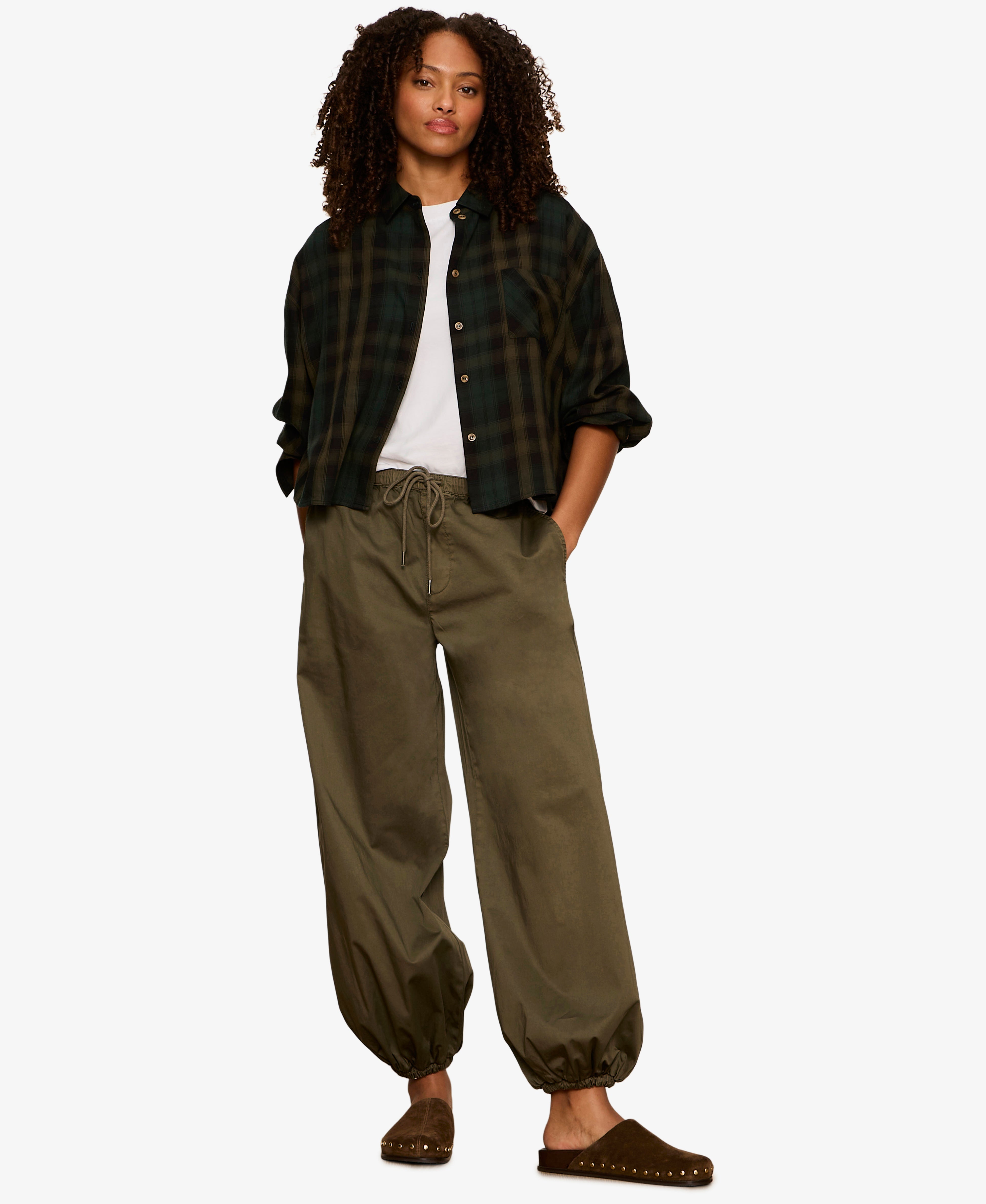 Model wearing Sanctuary Float On Balloon pants in kalamata olive green with drawstring waist