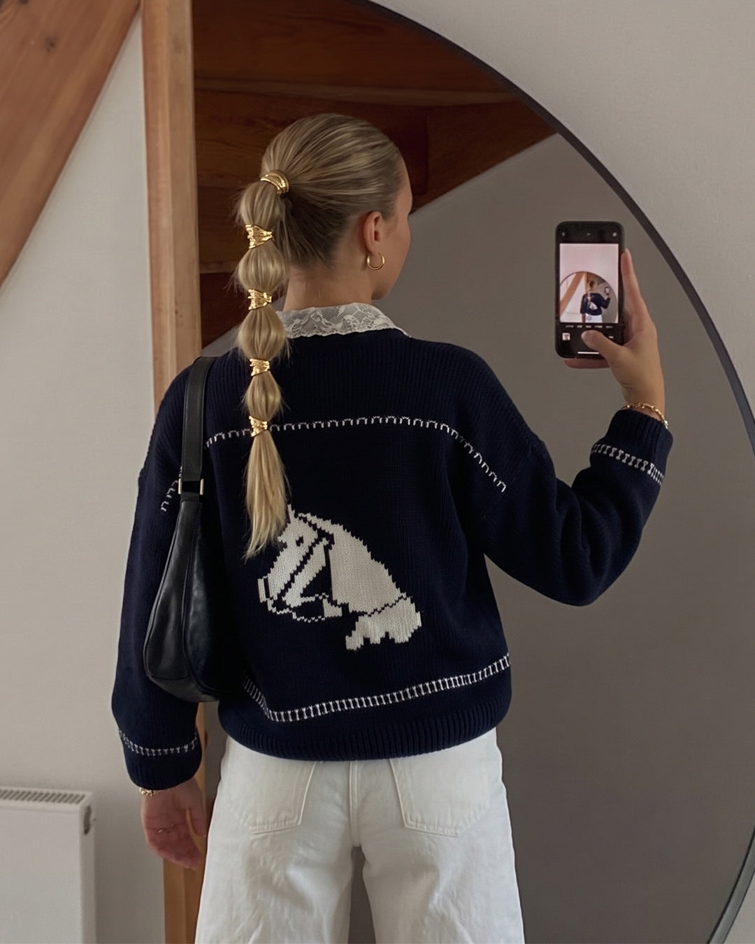 Navy knit cardigan with white horse intarsia graphic and contrast stitch detailing
