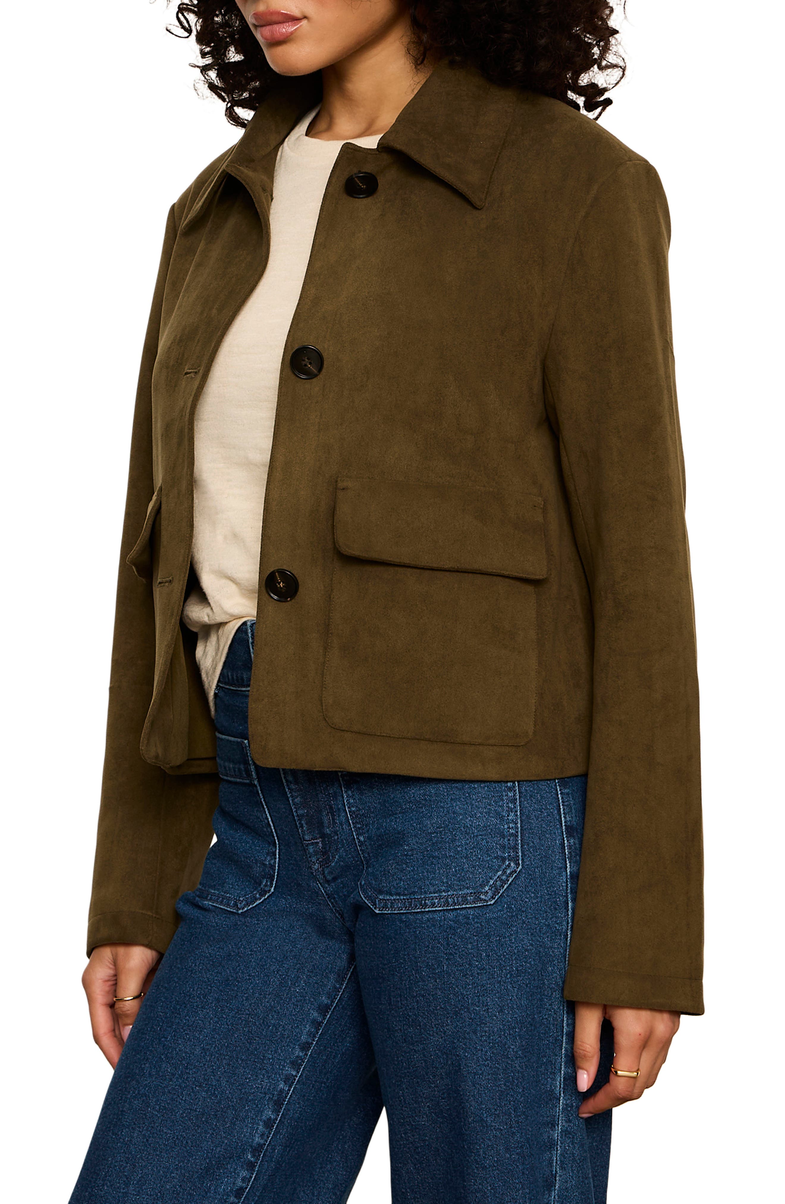 Woman wearing olive green suede button-front cropped jacket with patch pockets and jeans