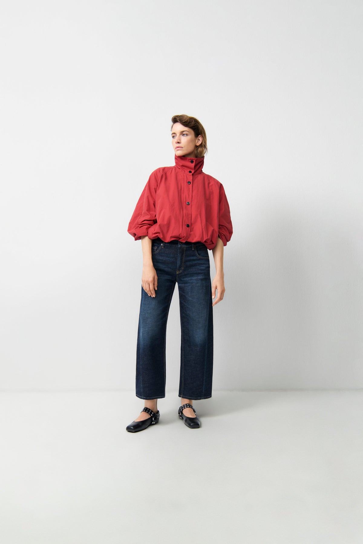 Model wearing Cambio Oria Cross dark soft tea wide-leg cropped jeans with red jacket