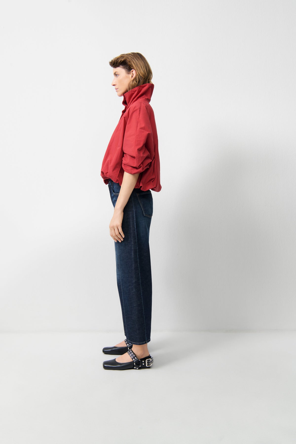 Model wearing Cambio Oria Cross dark soft tea jeans in side profile view